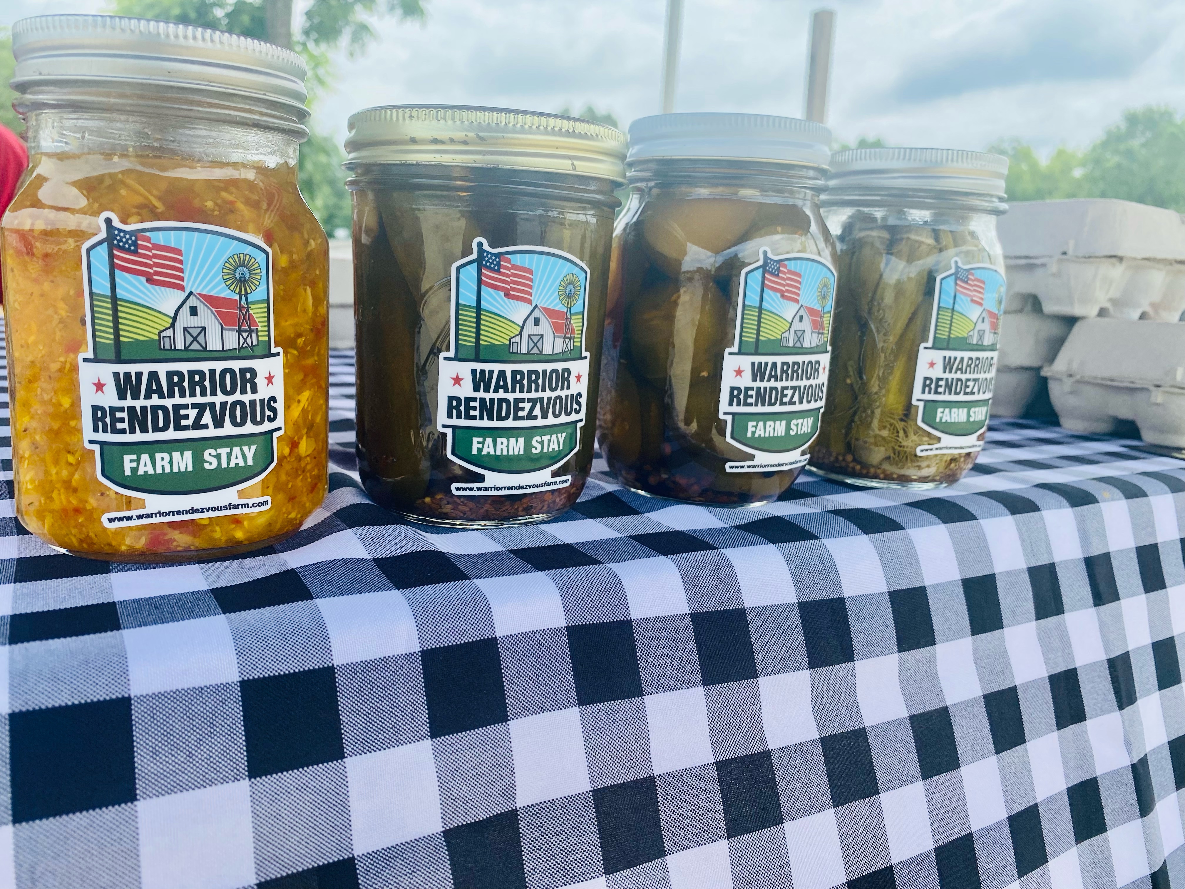 Farm table spread with Warrior Rendezvous preserves and produce